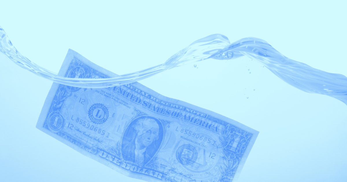 US dollar bill submerged in water.